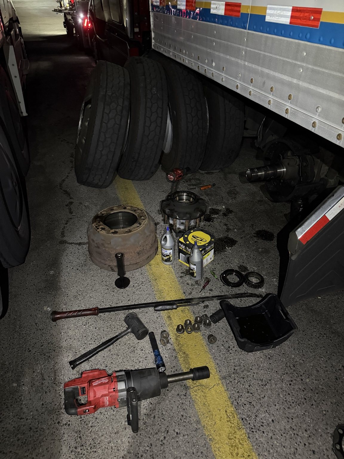 Wheel-end repair at night on a commercial truck